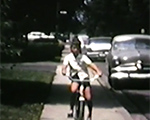 8mm_01_102 Carrollton - Susan riding bike - John